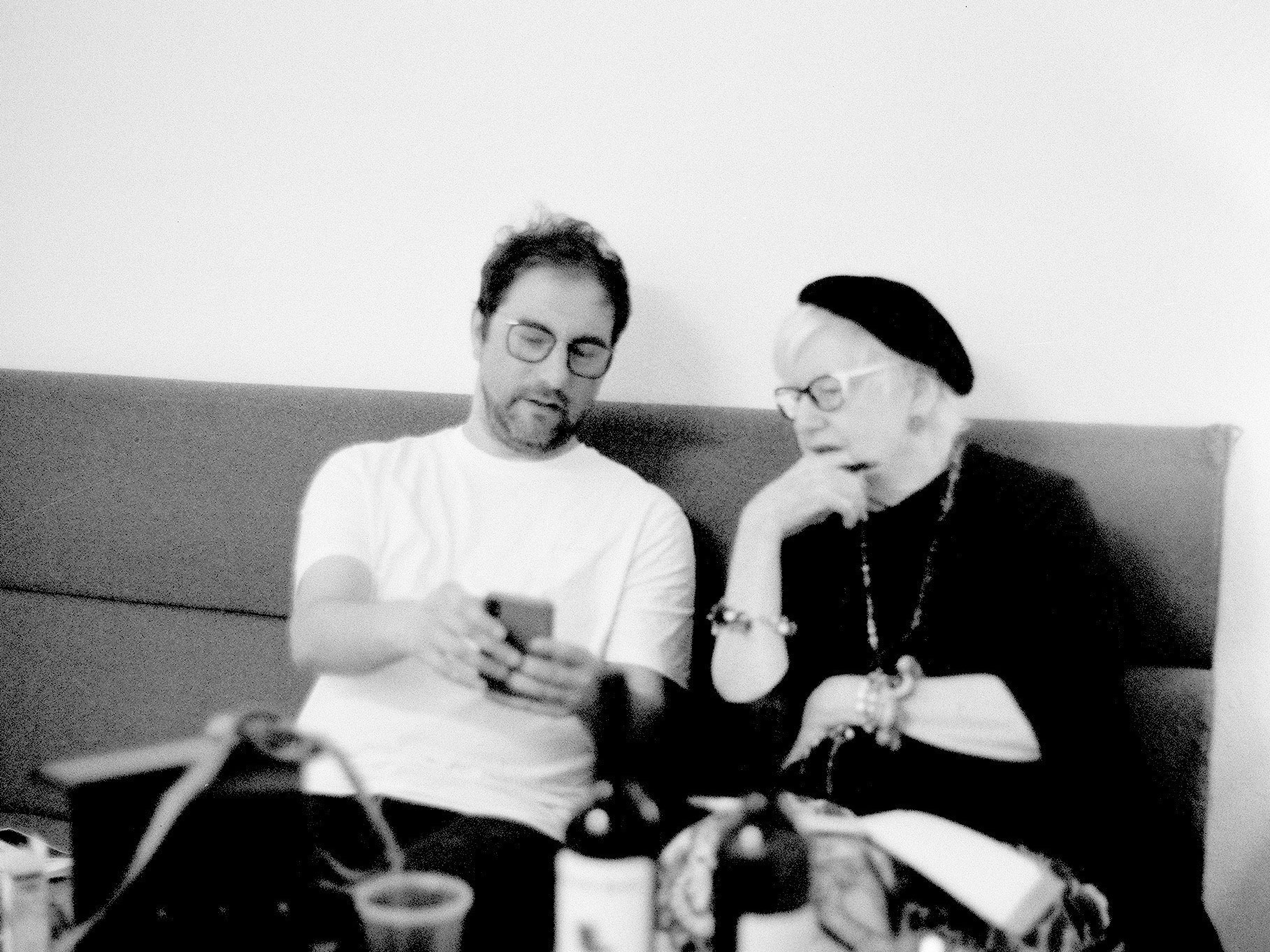 Two people sitting on a sofa.