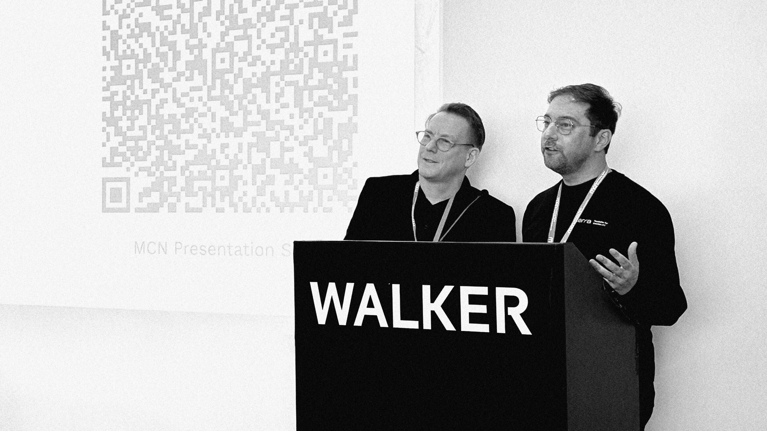 Two men standing at a lectern